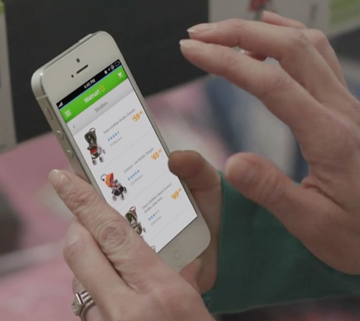 Person holding phone with screen from Walmart 