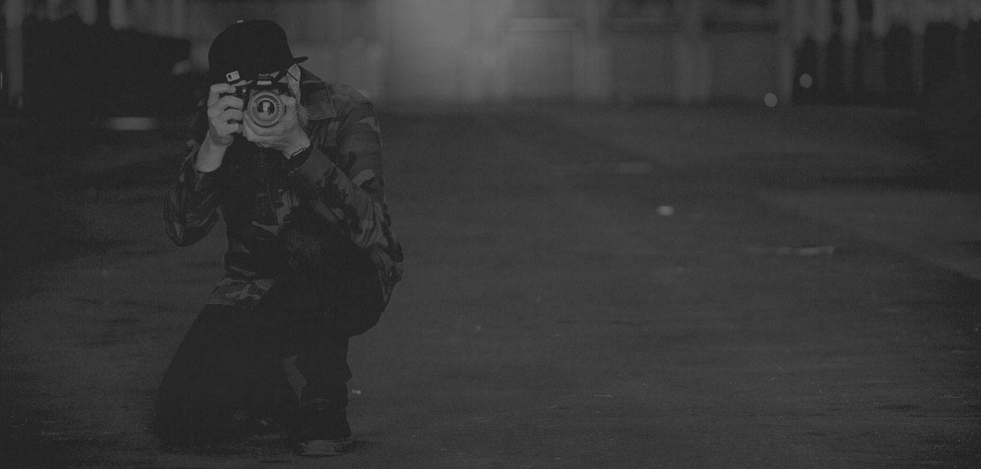 Michael Cobra with camera kneeling to take a photo