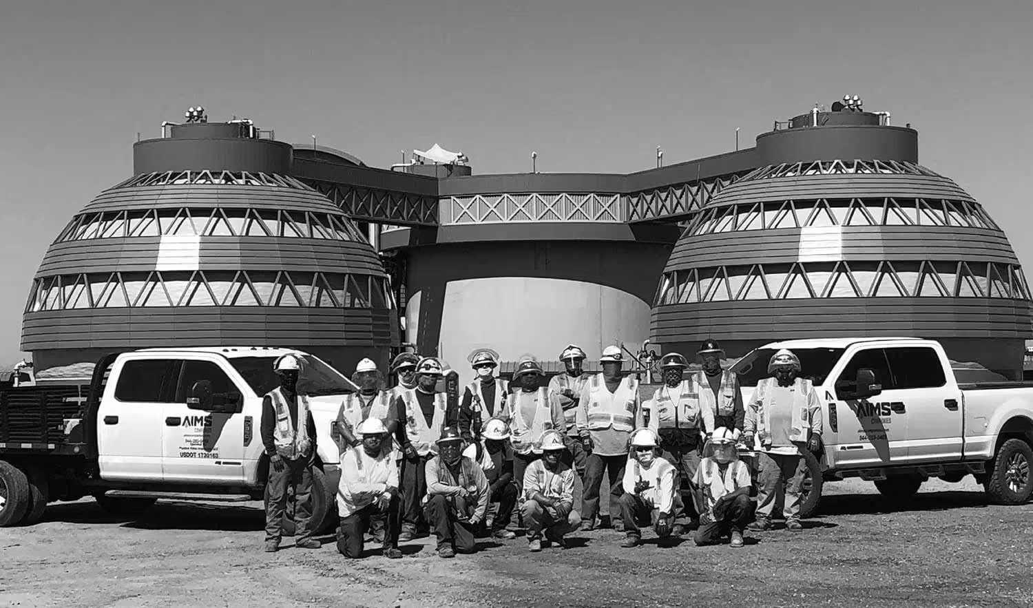 A photo of the AIMS Coating Team, standing in front of a service project
