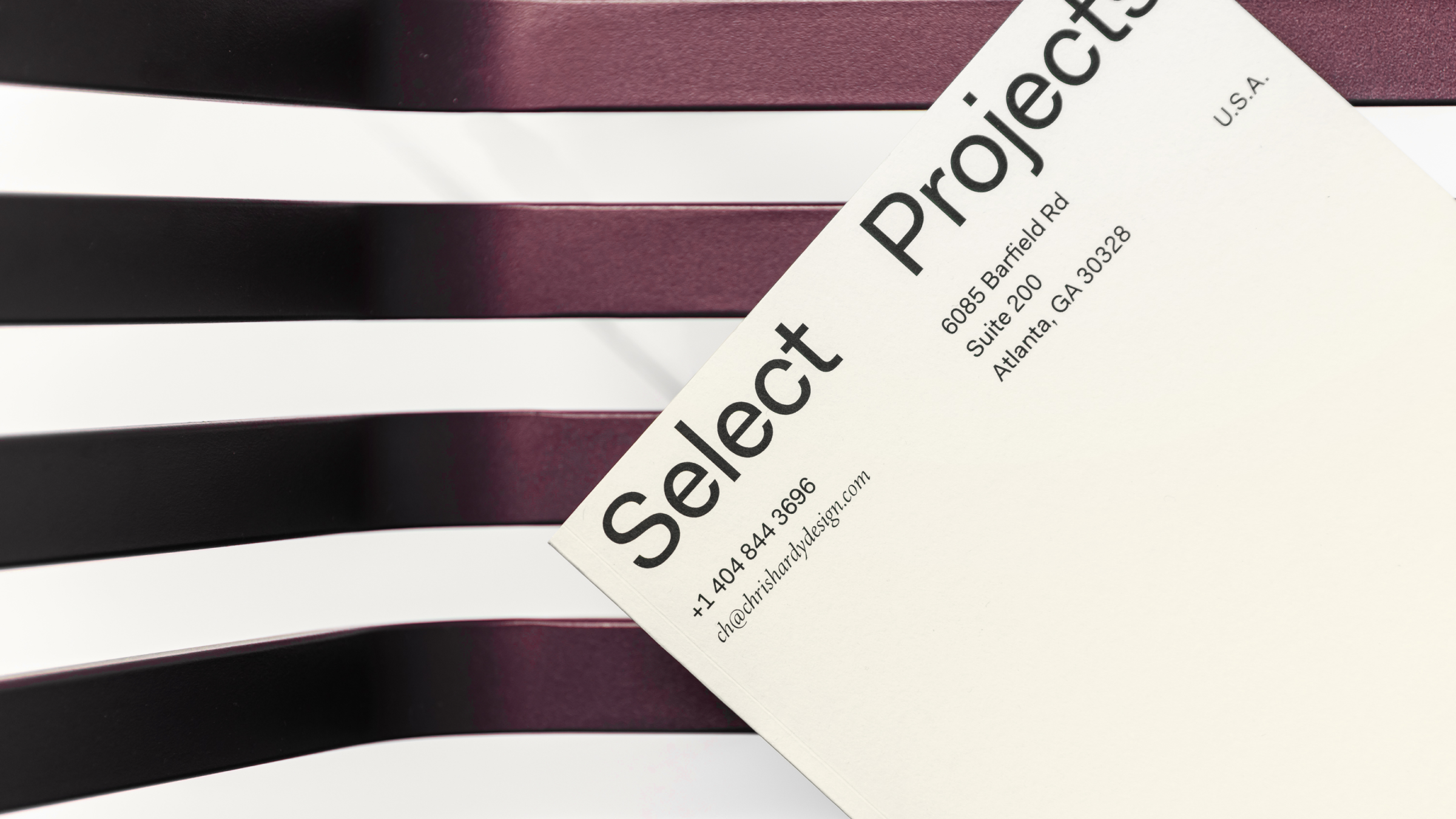 Close-up of a business card with contact details placed on a piano keyboard.