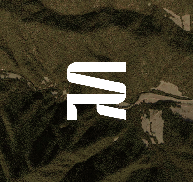 White stylized initials 'SR' logo centered over an aerial view of green and brown forested mountainous terrain.