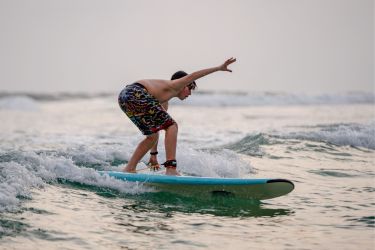 Kid practicing surfing in lower waves