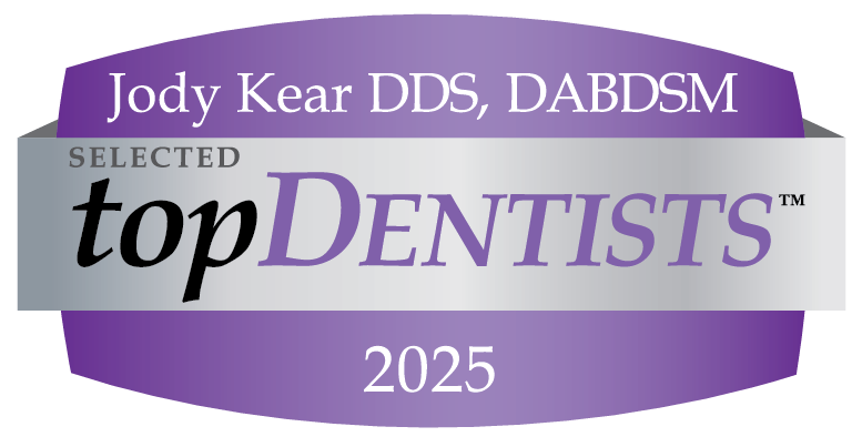 A purple and silver badge reads “Jody Kear DDS, DABDSM - Selected topDentists 2025,” highlighting this dentist’s achievement at Greentree Dental Group.
