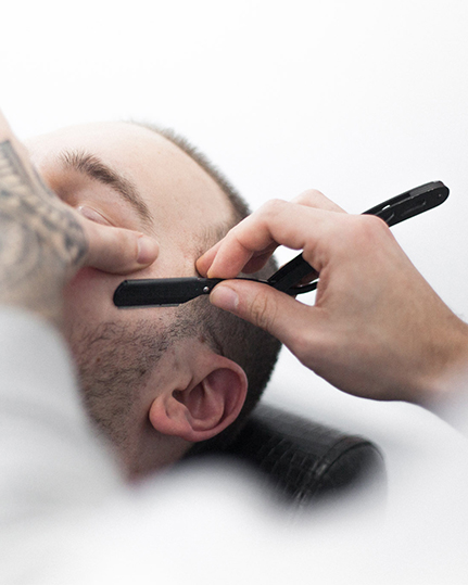 Hot towel shave with blade.