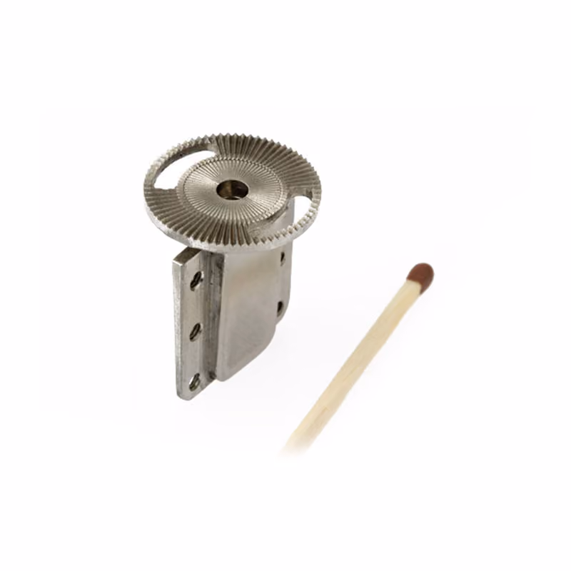 Miniature machined part next to a pencil tip for scale