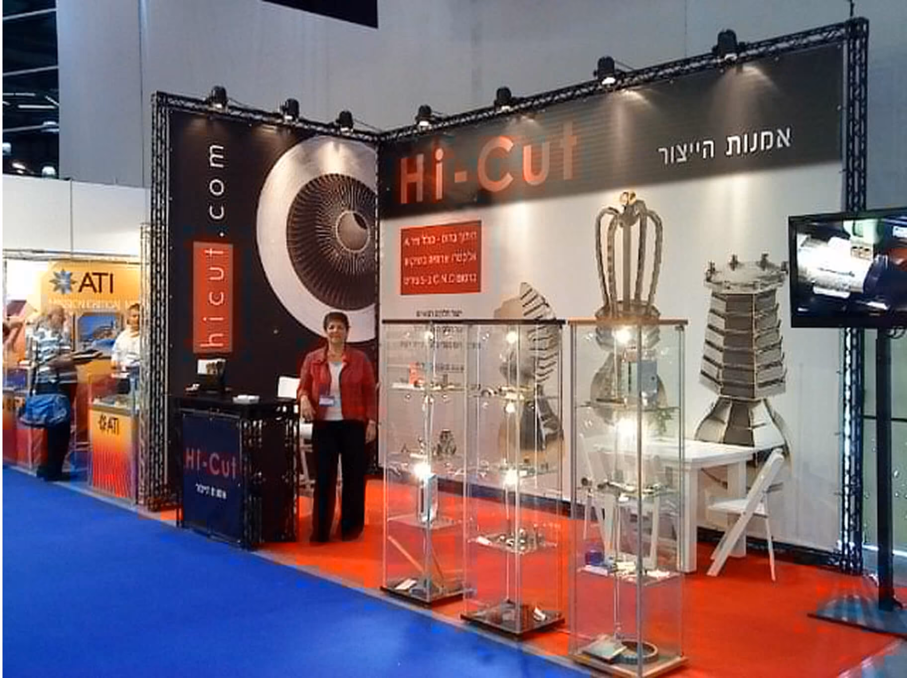 Hi-Cut exhibition booth with display cases of precision parts