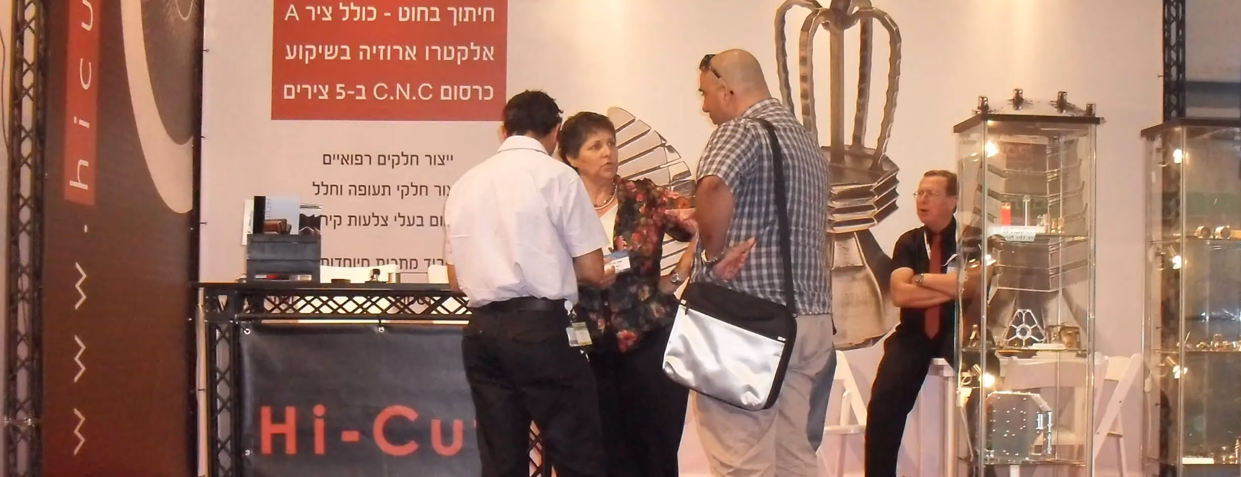 Hi-Cut team speaking with visitors at the trade show booth