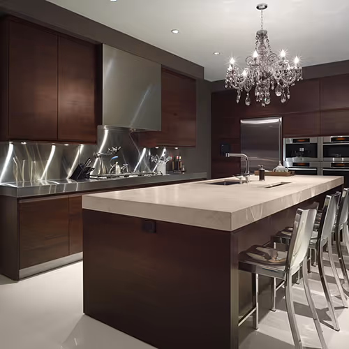 Luxurious kitchen with fantastic ligting, island and chairs.