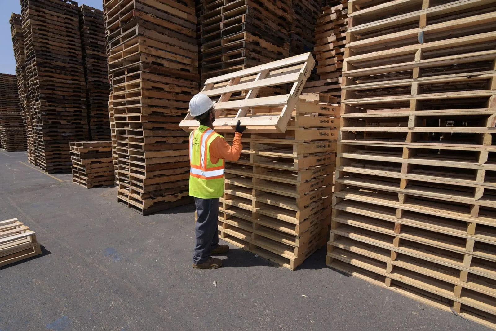 employee organizing pallets