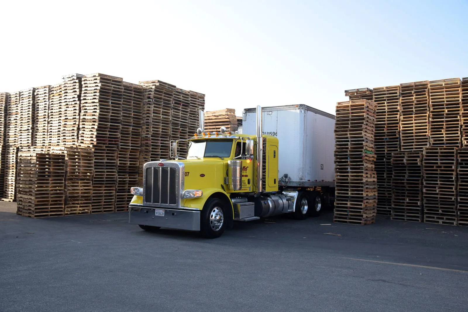 truck parked in between pallets