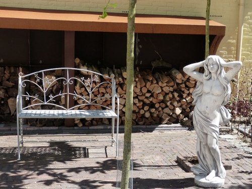 Beelden en ornamenten sieren deze tuin.