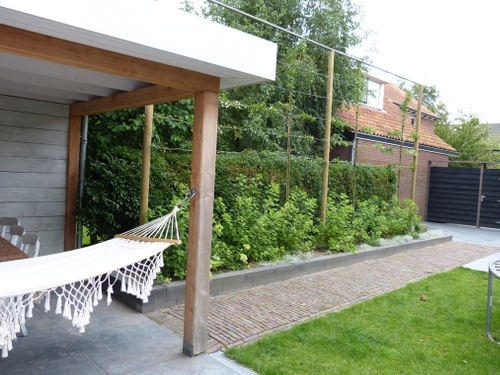 Het klinkerpad verbindt de twee terrassen met elkaar.