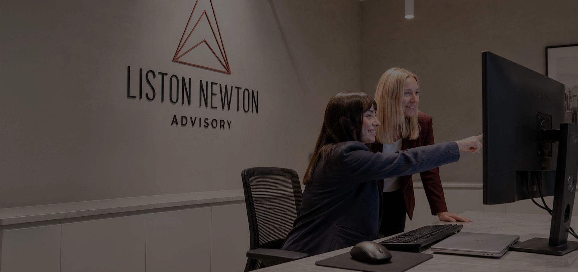 Liston Newton team members mentoring and collaborating in the office.