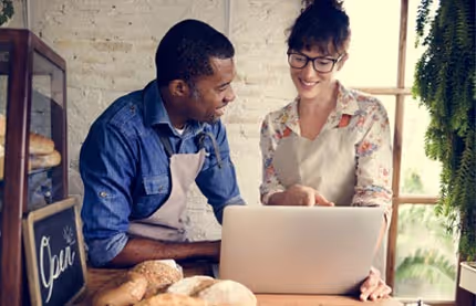 Two people looking at a laptop