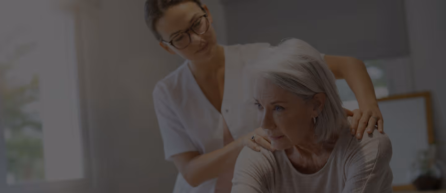 A practitioner guiding a patient through a hands-on treatment on a treatment table.