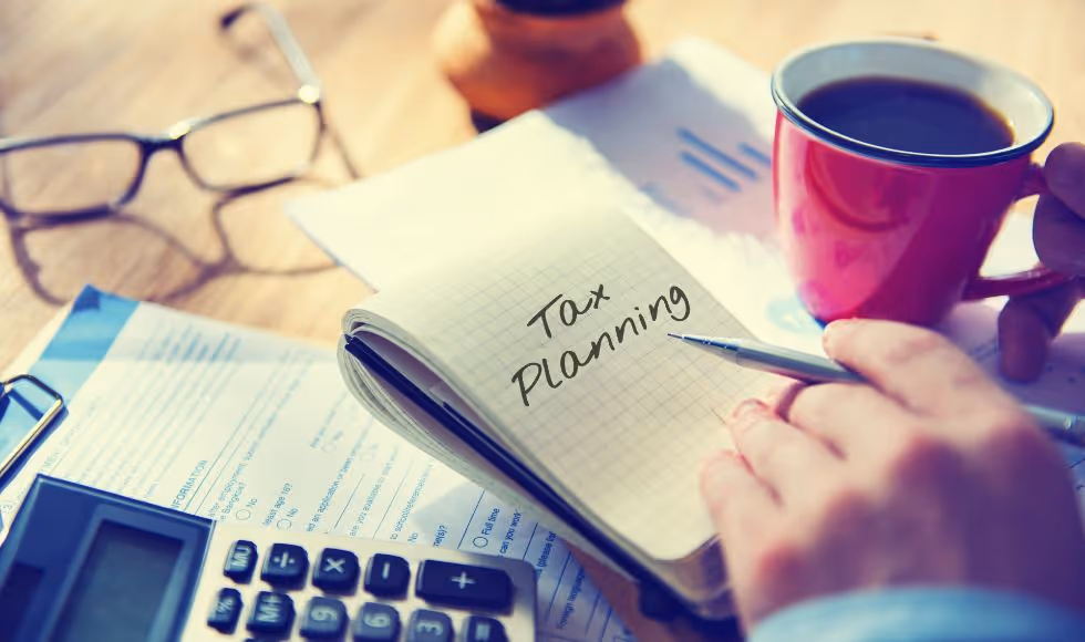 person making notes to plan their taxes