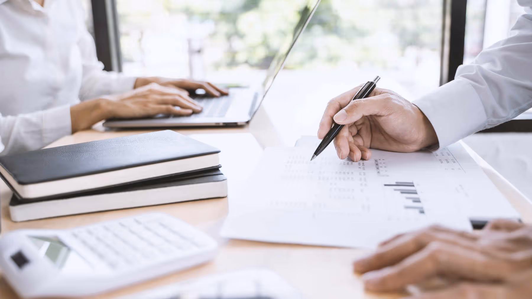 man calculating corporate tax