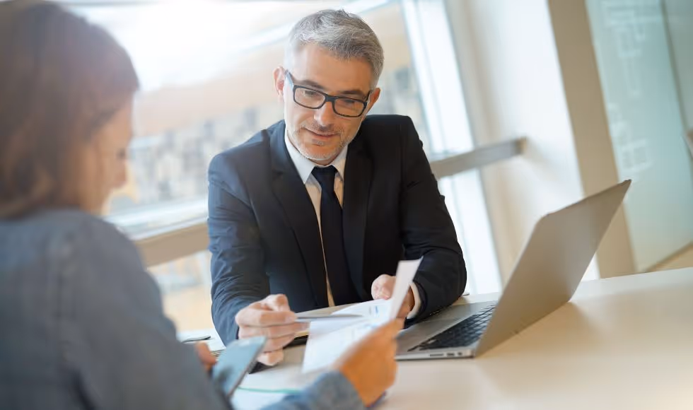 client with their accountant reviewing financial documents