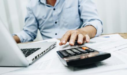 Person working out tax with calculator