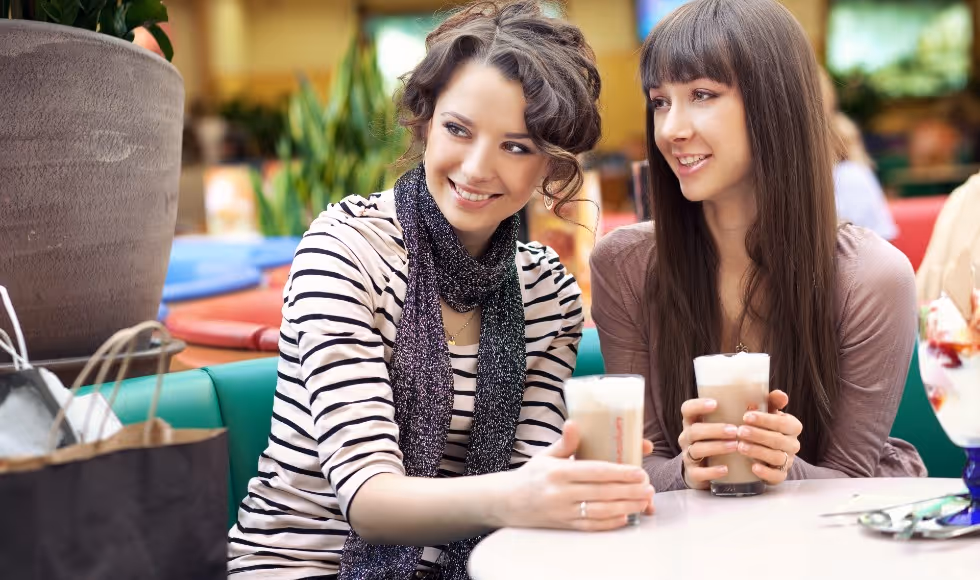 women enjoying coffee in food court
