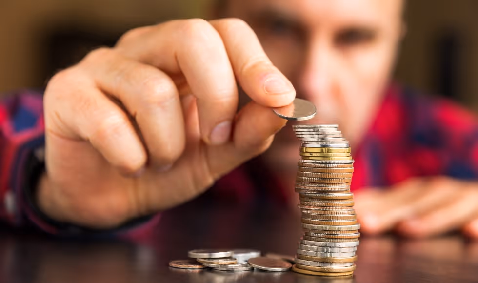 man stacking coins