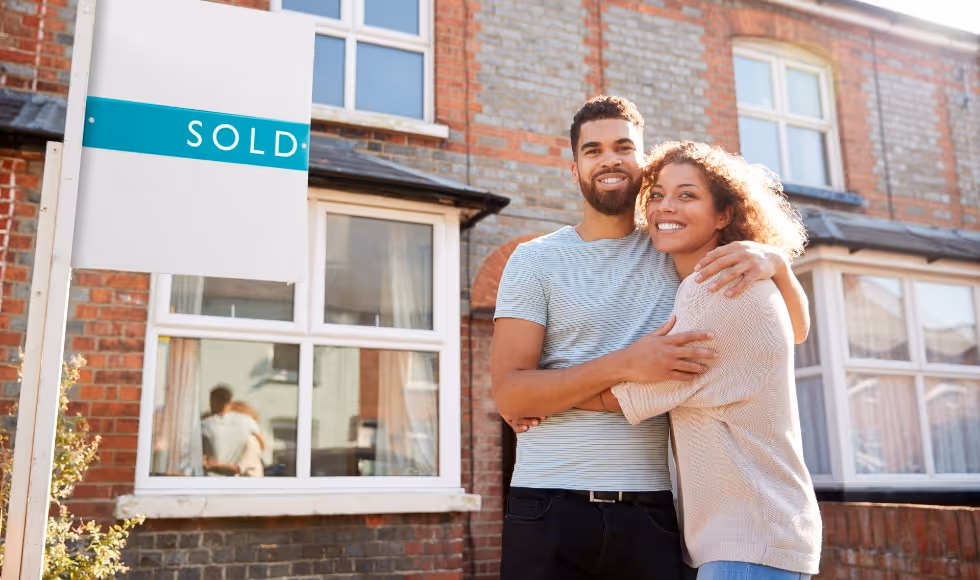 couple standing outside new home