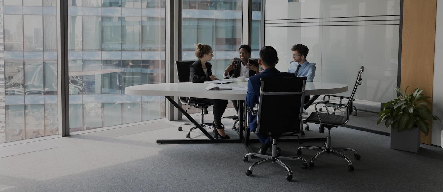 Modern office interior with a small team of business accountants having a meeting 