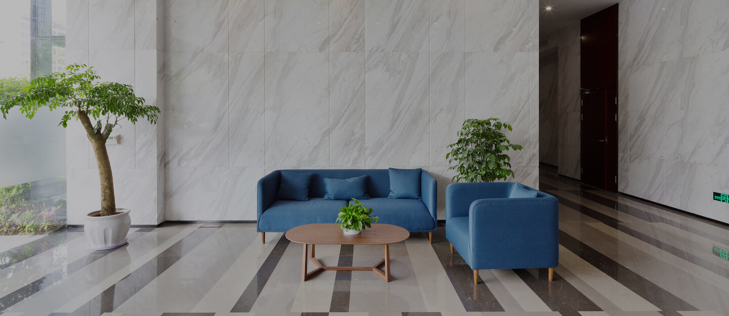 Two blue sofas and a coffee table in an office atrium