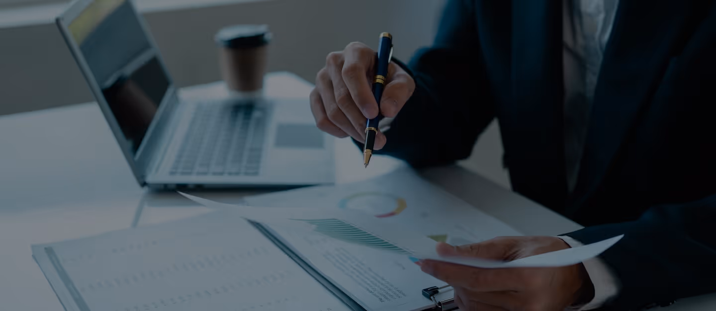 A planner tracing a projection curve on a chart while a client watches across the table.