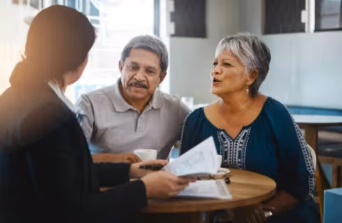A retirement investment advisor providing personalized financial guidance to an elderly couple, focusing on building secure and confident retirement plans.