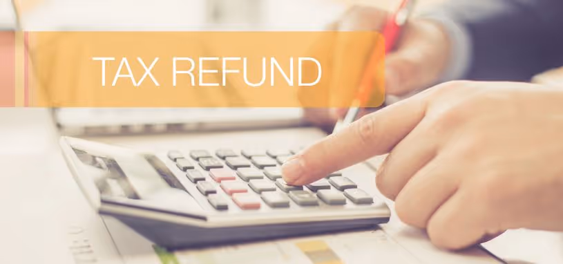 person using a calculator to work out tax refund