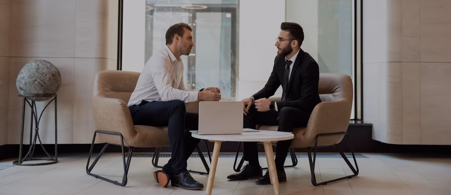 Two financial planners seated in a discussion