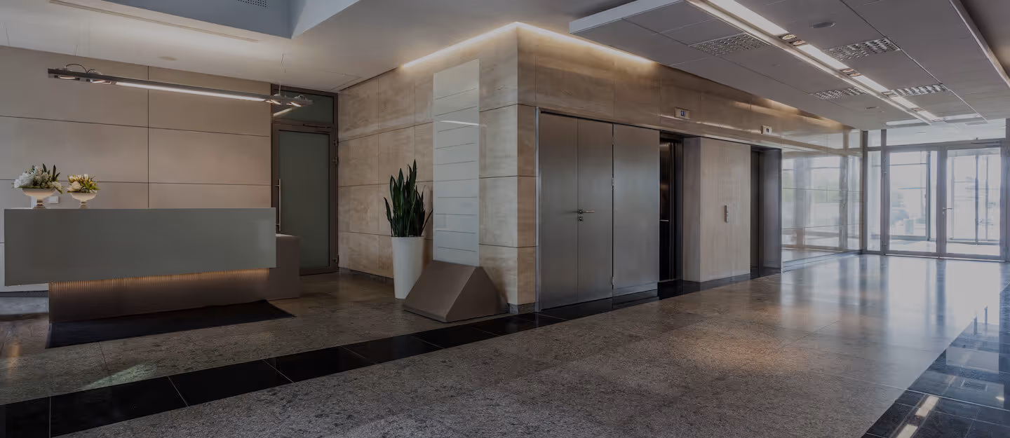 Office building with reception counter and two elevators