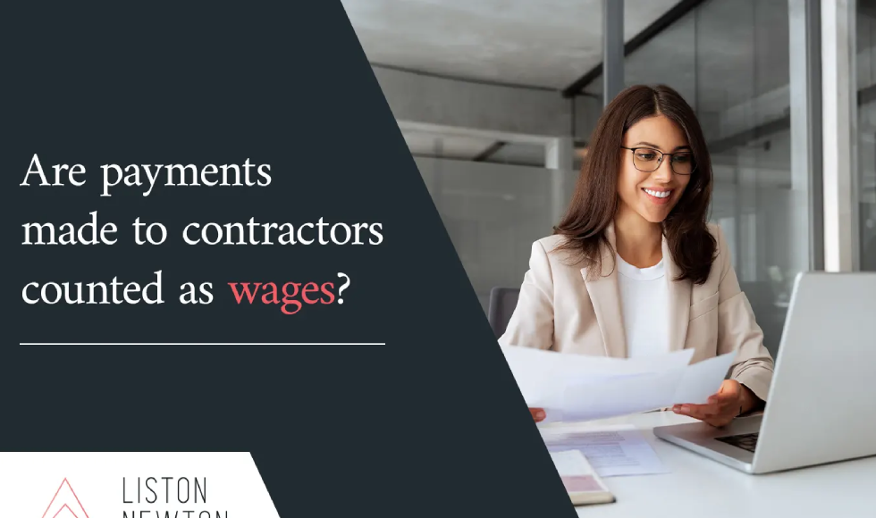 Businesswoman smiling while reviewing paperwork at a laptop beside the headline Are payments made to contractors counted as wages