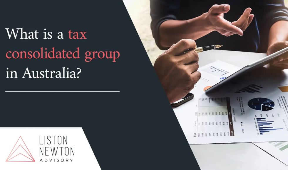 Business meeting scene with hands reviewing financial charts on a tablet beside printed reports for an article on tax consolidated groups in Australia.