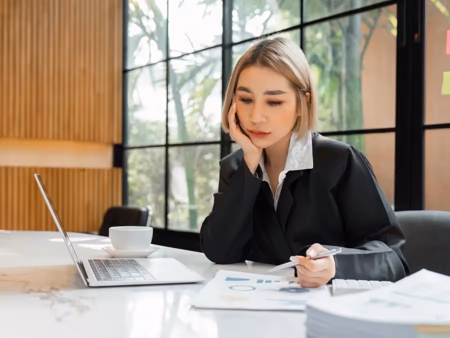 A young female professional shows worry about her finances.
