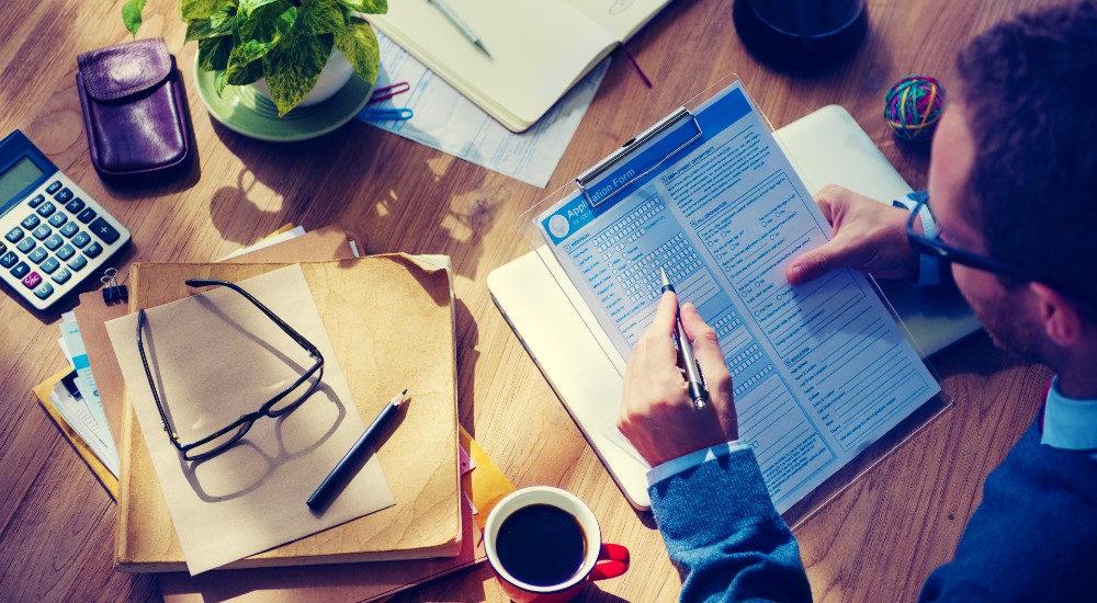 business man filling out application form