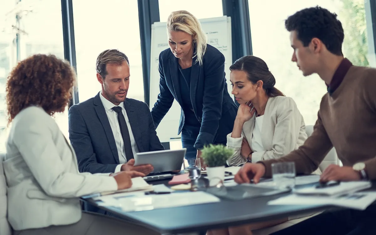 A group of professionals huddled during a discussion