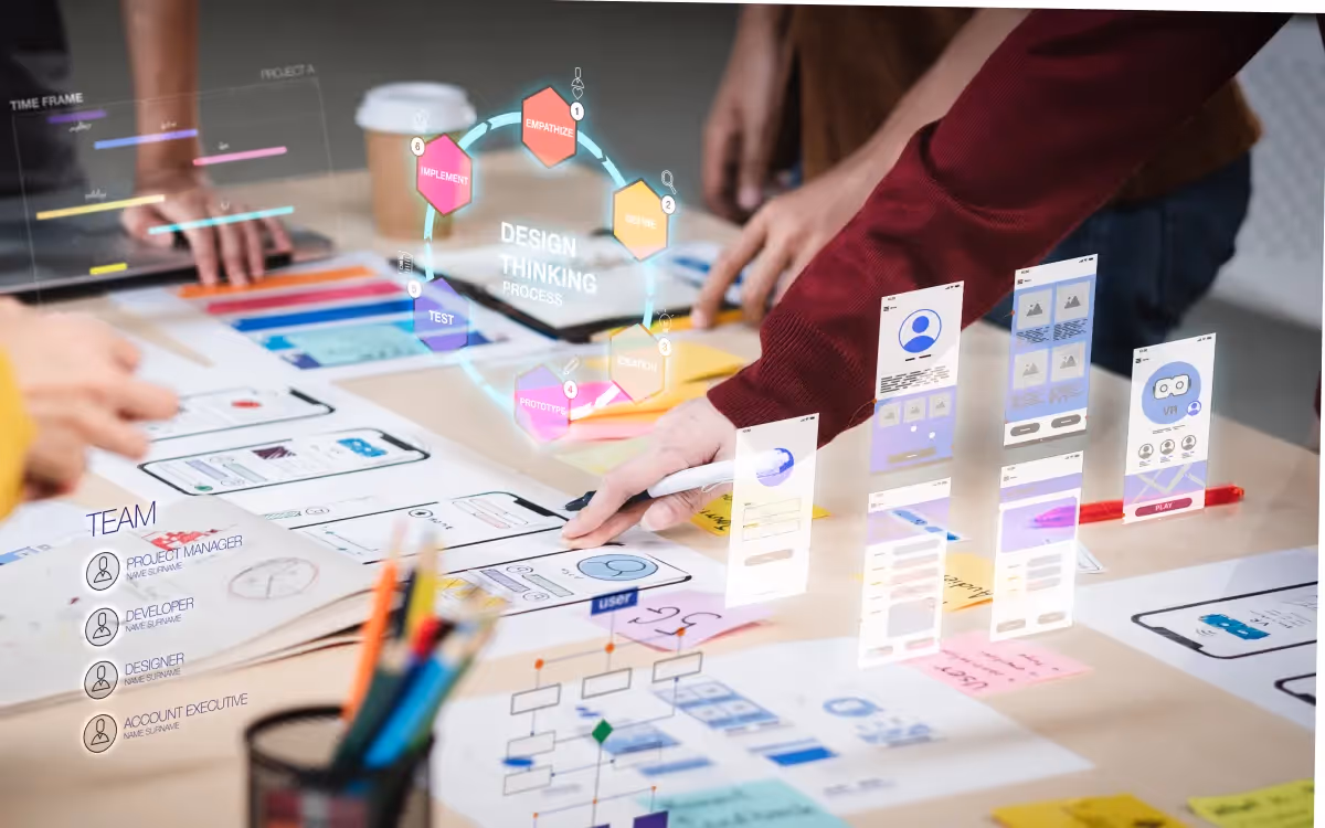 Close-up of a UX developer and UI designer using augmented reality to brainstorm a mobile app interface wireframe on a desk in a modern office.