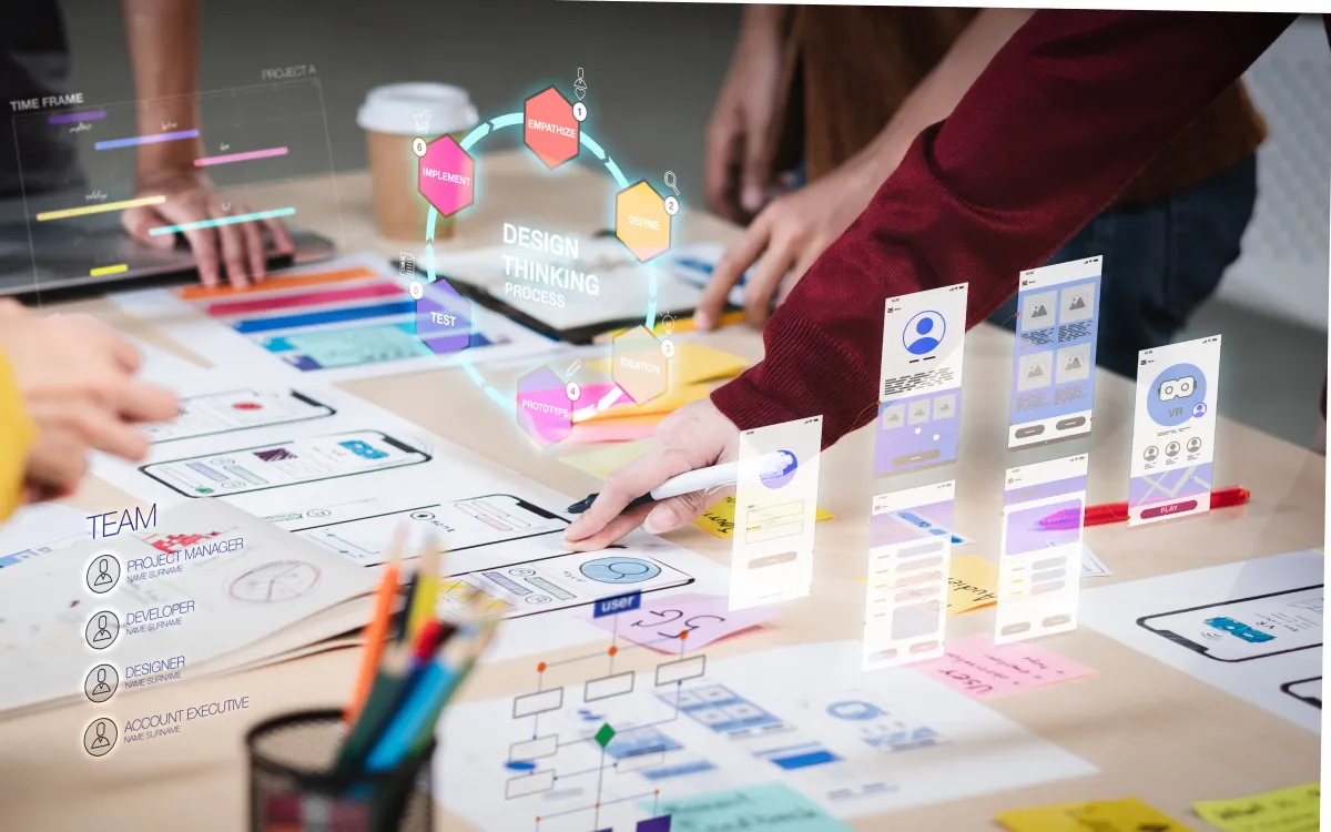 Close-up of a UX developer and UI designer using augmented reality to brainstorm a mobile app interface wireframe on a desk in a modern office.