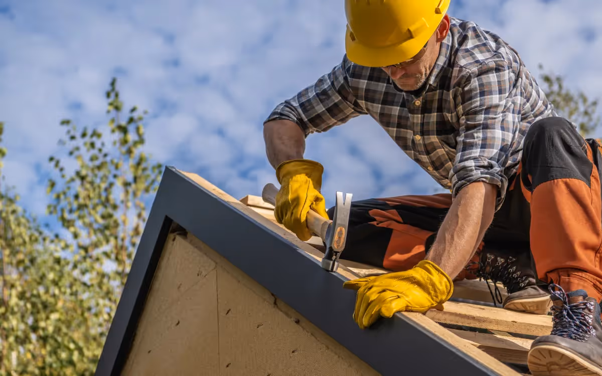 A male builder working on a roofing installation
