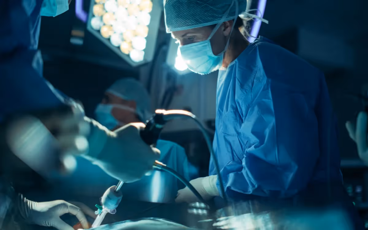 Surgical team inside an operating theatre while treating on a patient.
