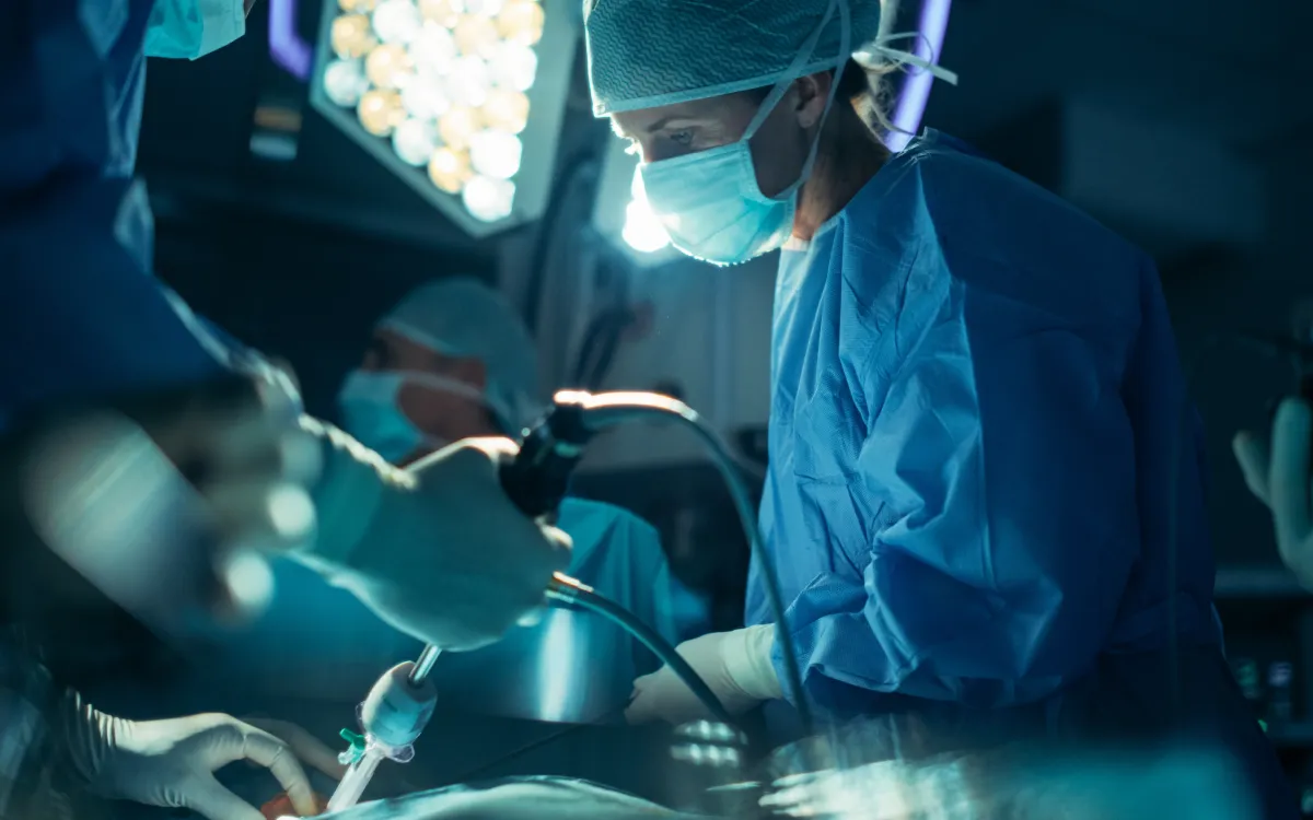 Surgical team inside an operating theatre while treating on a patient.