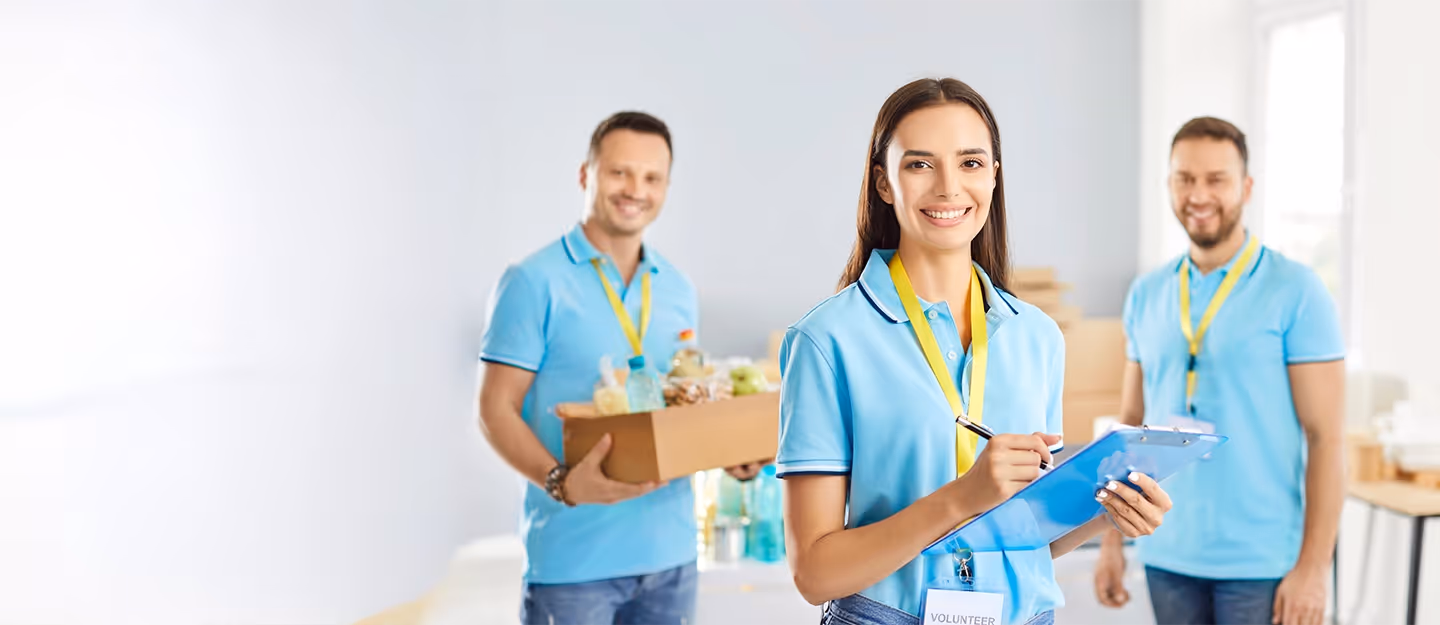 Volunteer organisation staff using administrative and accounting processes to support charitable operations and community programs.
