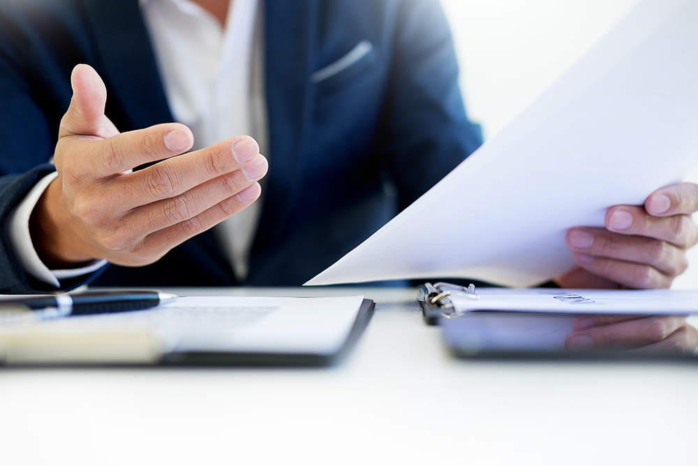 Stock photo of mans hands and paper