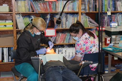 student receiving dental care in school