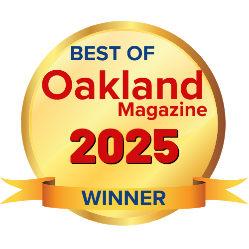 Round gold emblem with verbiage that reads, Best of Oakland Magazine 2025 Top 5