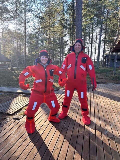 Guests experiencing the unique sensation of daytime floating amidst the vibrant autumn colors of the Arctic forest.