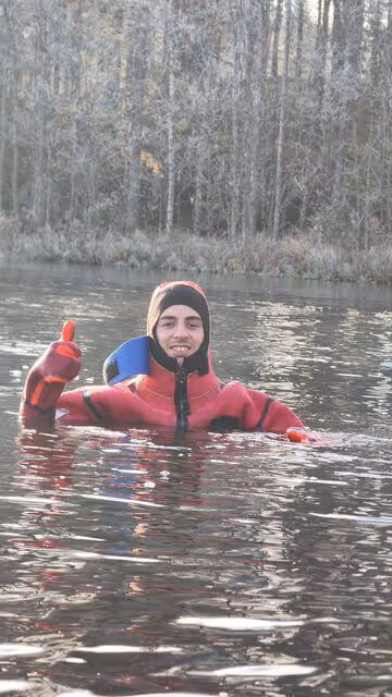 Close-up of a floating suit with a person inside, showcasing the warmth and comfort provided during a unique lake floating adventure.