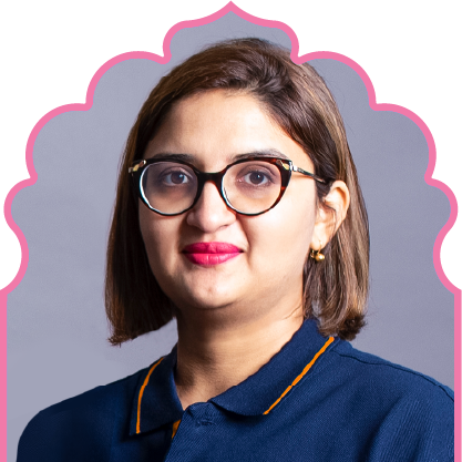 Woman with short brown hair wearing black-rimmed glasses and a navy blue collared shirt with orange trim.